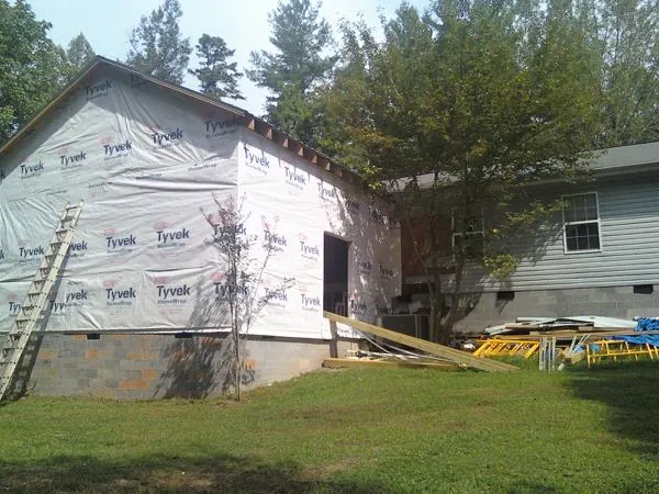 Tyvek wrapped gable on a new room addition beside an existing home in Ulysses